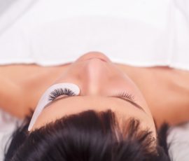 64296101 - eyelash extension procedure. woman eye with long eyelashes. lashes. close up, selected focus.